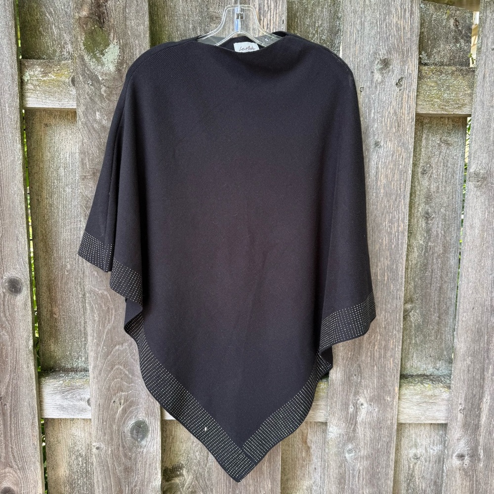 Black poncho with shiny border detail